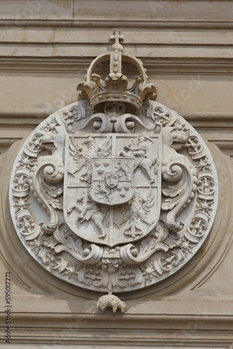 Vertical shot of the Coat of arms adorning a wall inside the Wawel royal castle, Krakow, Poland