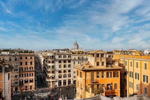 View from the top of the Spanish Steps overlooking the buildings and people in Rome, Italy.