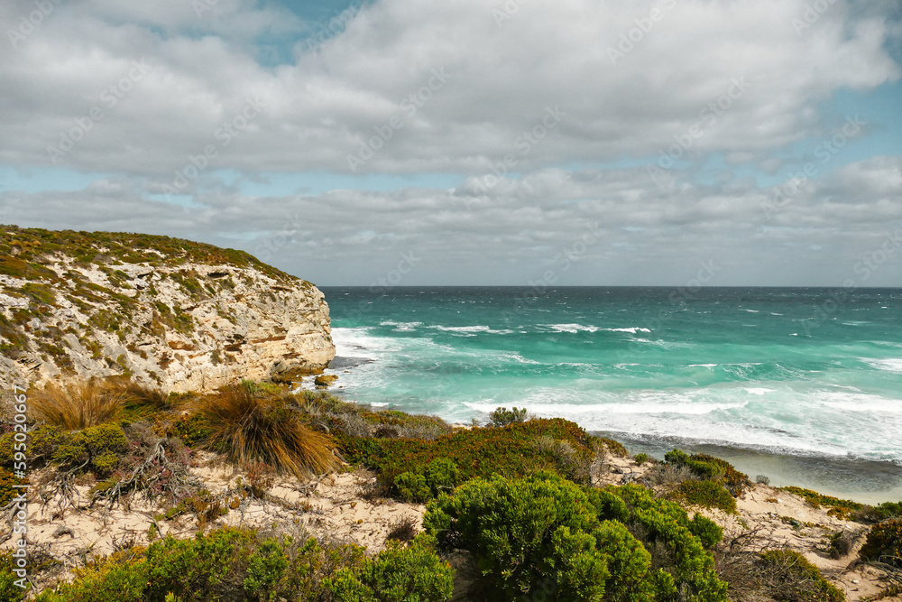 Coastal Scenery: Seashore View with Coastline Rocks and Sky Blue Water