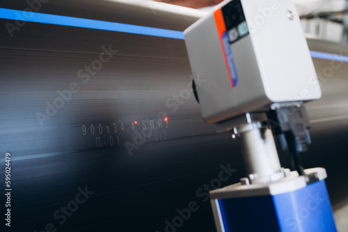 Laser Marking Machine Engraving. Manufacture of plastic water pipes of the factory.