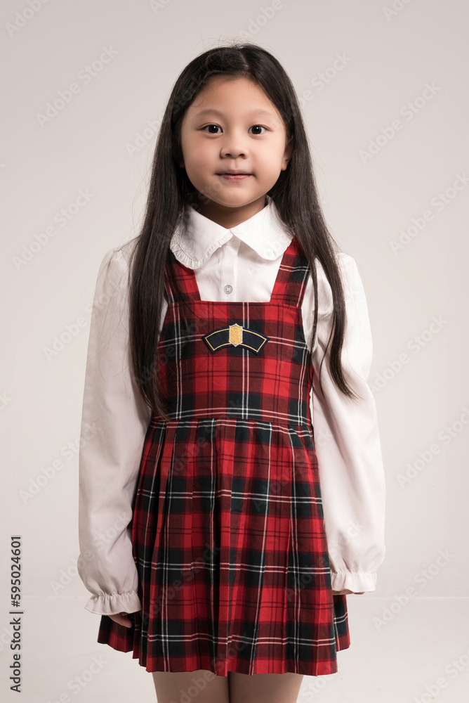 portrait of a little girl standing over white background.