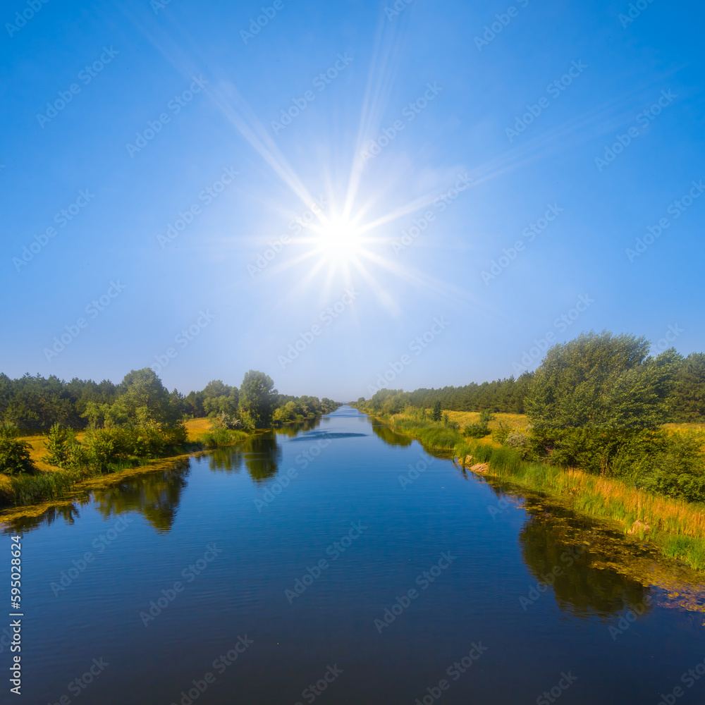 Obraz premium irrigation channel under a sparkle sun, summer irrigation engineering scene