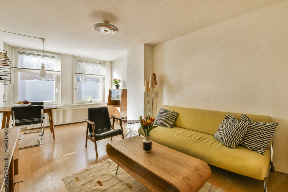 a living room with a couch, coffee table and television set in the corner on the wall is painted white a living room with a couch, coffee table and television set in the corner on the wall is painted white
