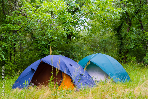pair of touristic tent in a forest  summer touristic camp scene