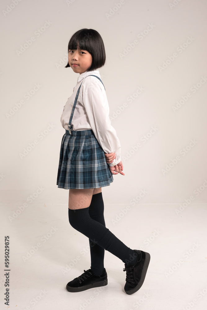 portrait of a little girl standing over white background.