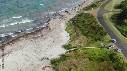 Female kite surfer on beach 
