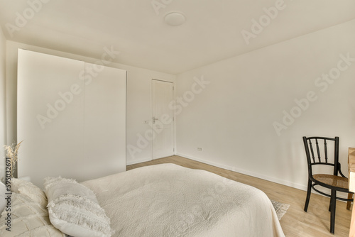 a bedroom with a bed  chair and mirror on the wall in front of the door to the other room