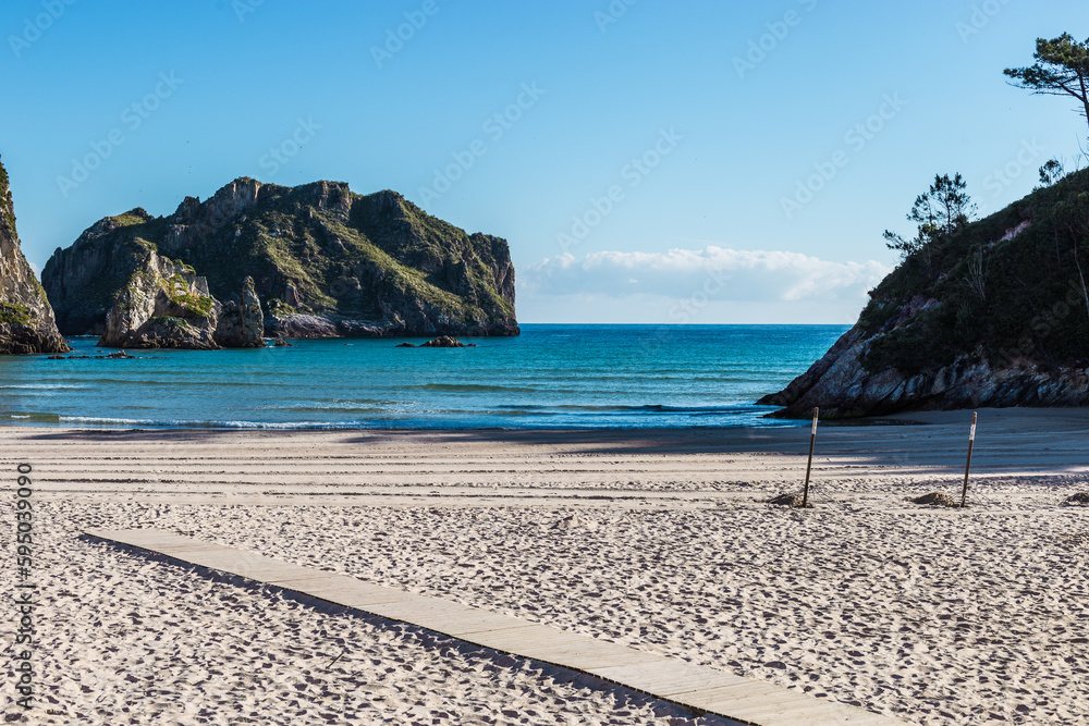 Beach with mountains and wooden walkway