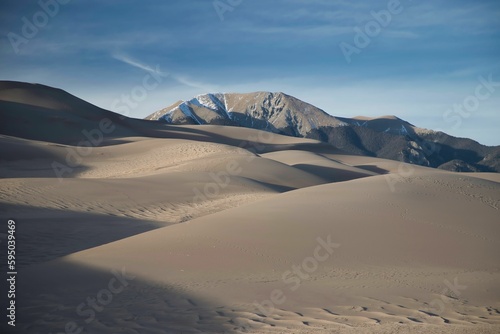 Landscape of sand dunes in a desert under the sunlight