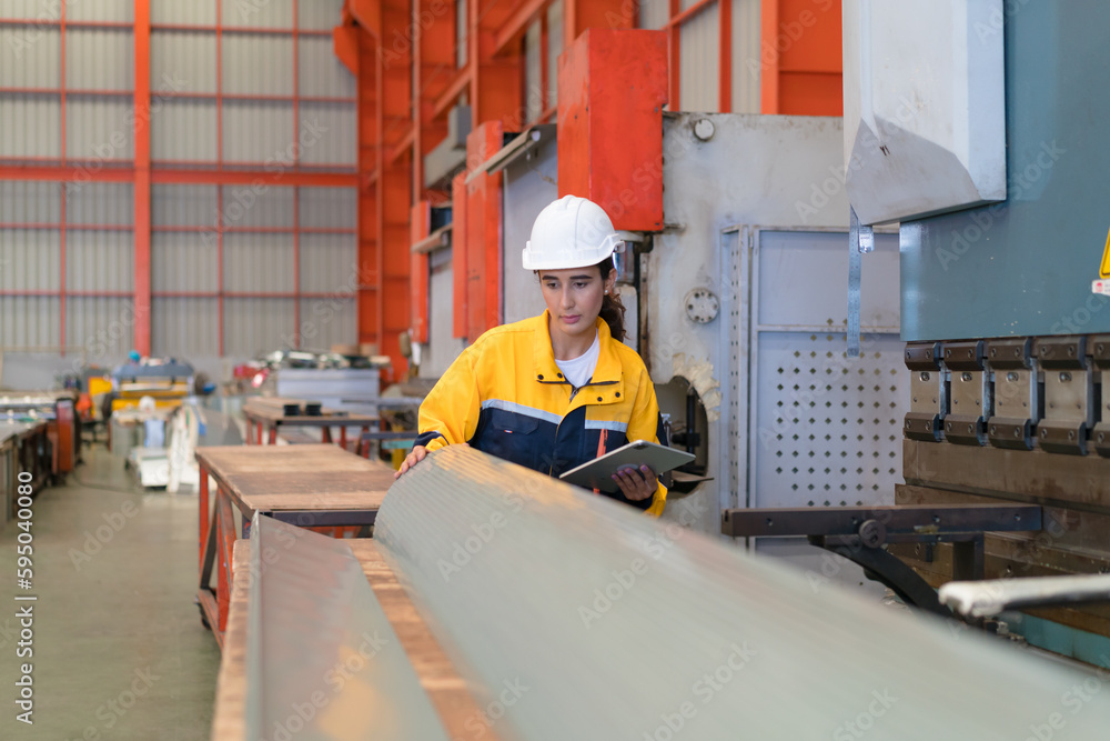Professional heavy industry engineer worker wearing safety uniform in a metal manufacture warehouse , maintenance service check for safety first concept . Professional heavy industry engineer worker wearing safety uniform in a metal manufacture warehouse , maintenance service check for safety first concept .