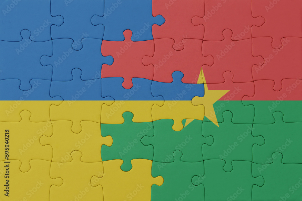 puzzle with the national flag of ukraine and burkina faso . macro.concept. puzzle with the national flag of ukraine and burkina faso . macro.concept.