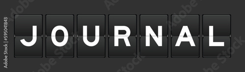 Black color analog flip board with word journal on gray background