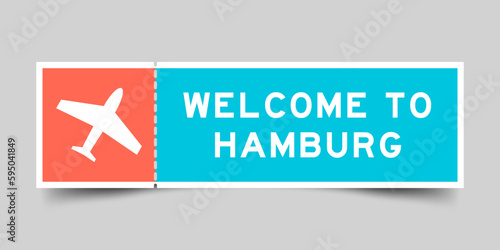 Orange and blue color ticket with plane icon and word welcome to hamburg on gray background