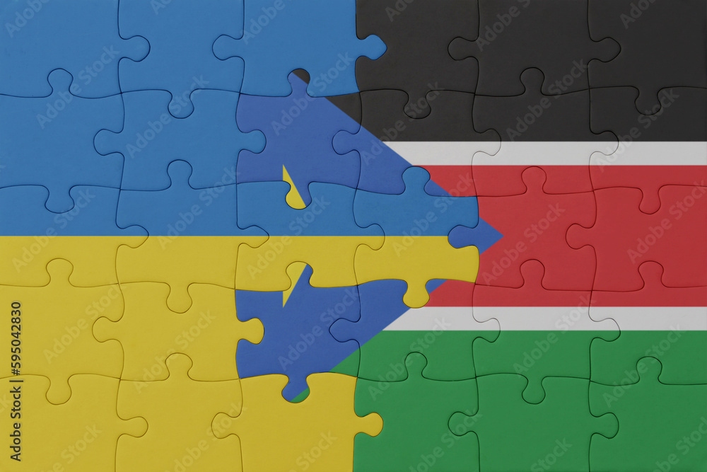puzzle with the national flag of ukraine and south sudan . macro.concept. puzzle with the national flag of ukraine and south sudan . macro.concept.