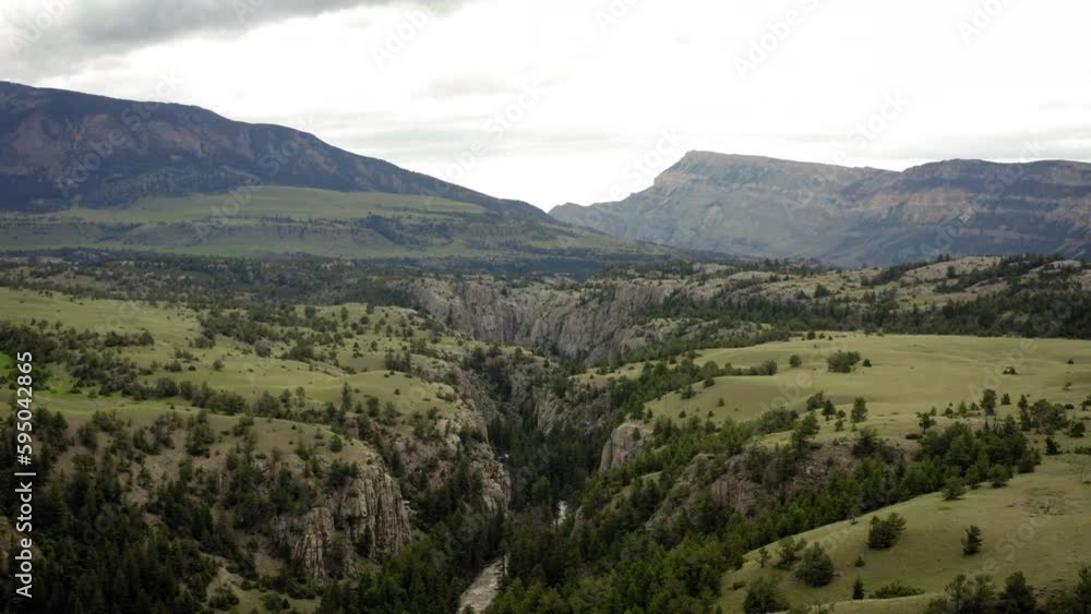 Drone view of a green mountains landscape in a valley on an overcast day Drone view of a green mountains landscape in a valley on an overcast day