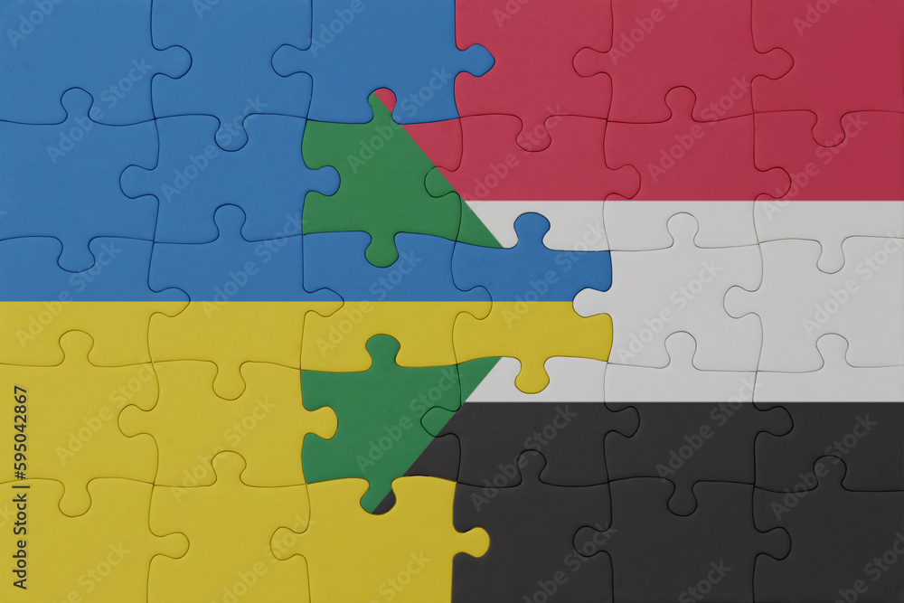 puzzle with the national flag of ukraine and sudan . macro.concept. puzzle with the national flag of ukraine and sudan . macro.concept.