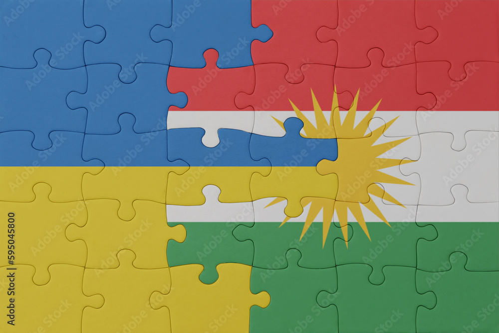 puzzle with the national flag of ukraine and kurdistan . macro.concept. puzzle with the national flag of ukraine and kurdistan . macro.concept.