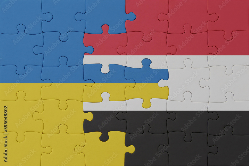 puzzle with the national flag of ukraine and yemen . macro.concept. puzzle with the national flag of ukraine and yemen . macro.concept.