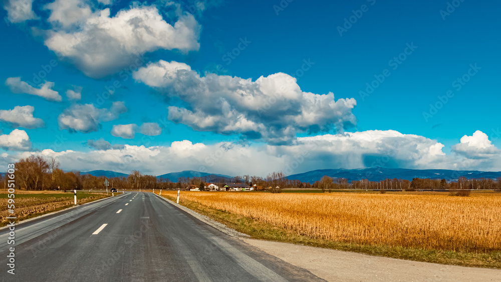 Winter landscape with dramatic clouds over the Bavarian forest on a sunny day near Aholming, Deggendorf, Bavaria, Germany