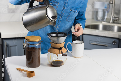 Woman making a pour over coffee at home