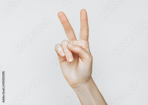 female hand making peace gesture