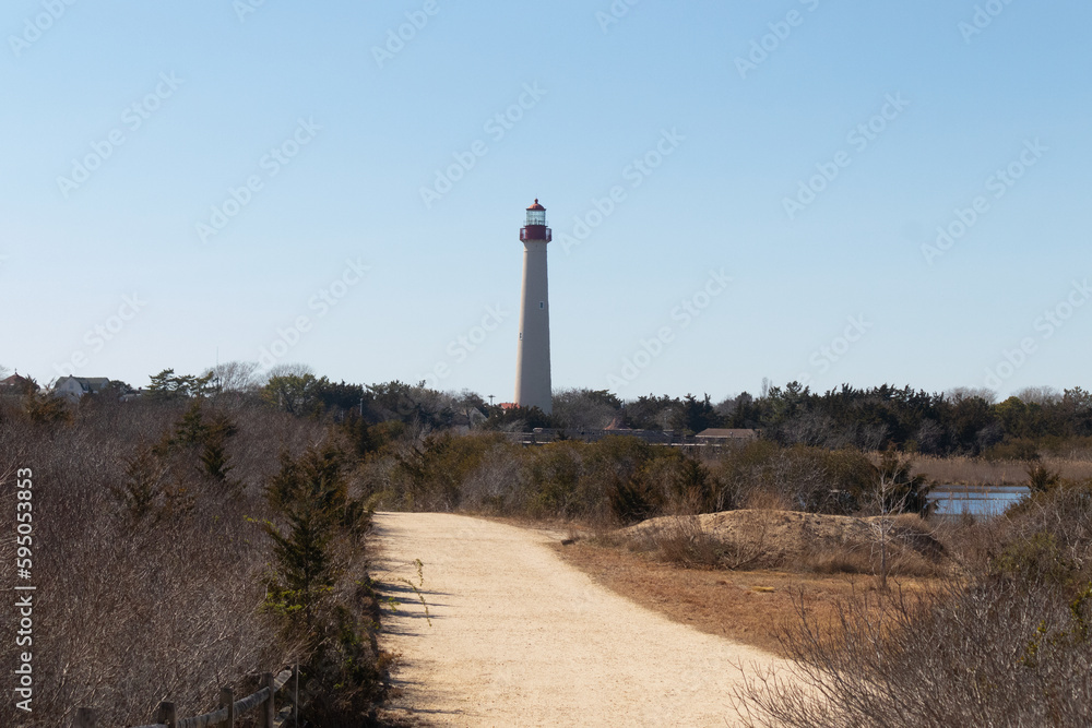 This is an image of Cape May Point lighthouse from a walking path that was close by. I love the red metal at the top of this lighthouse and the white tower. The beautiful walking path looks yellow.