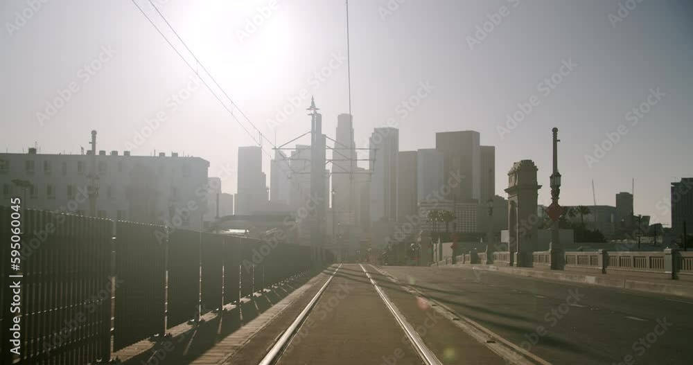 Empty street with tramway and skyline in the background on a sunny day during the Lockdown Empty street with tramway and skyline in the background on a sunny day during the Lockdown