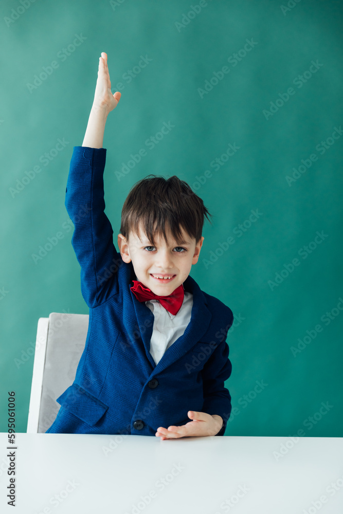 a boy in a lesson raises his hand school class a boy in a lesson raises his hand school class