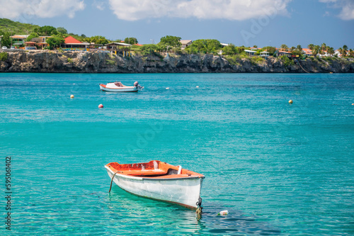 small boats, anchored in the sea, just off the coast of Playa Grandi beach, Curacao, Caribbean