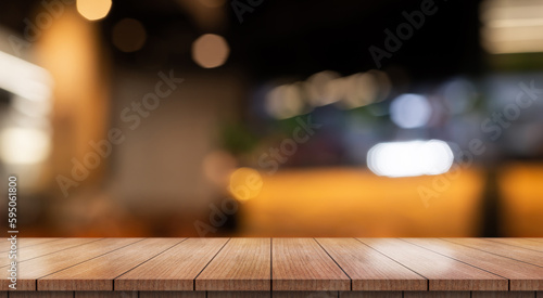 Empty wooden table top with lights bokeh on blur restaurant background.