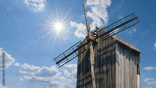  closeup winmill on sunny sky background, historical authentical scene time lapse scene photo