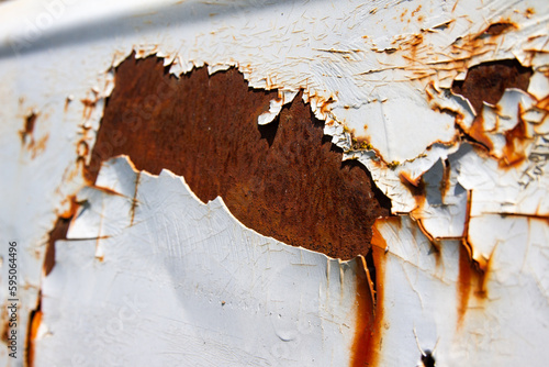 Rusted white painted metal wall. Rusty metal background with streaks of rust.