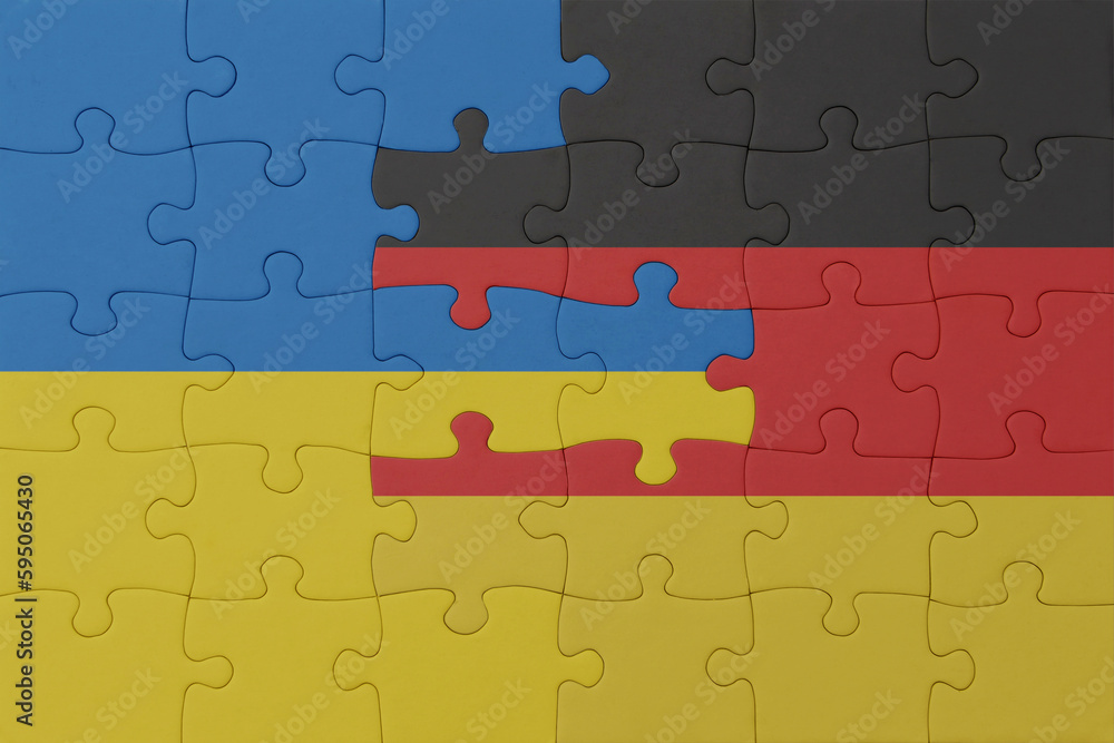 puzzle with the national flag of ukraine and germany . macro.concept. puzzle with the national flag of ukraine and germany . macro.concept.