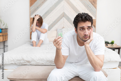 Tableau sur toile Frustrated and depressed man sitting on the edge of the bed after conflict with