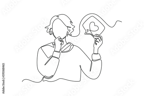 Single one line drawing happy woman holding social media love icon. Social media concept. Continuous line draw design graphic vector illustration.