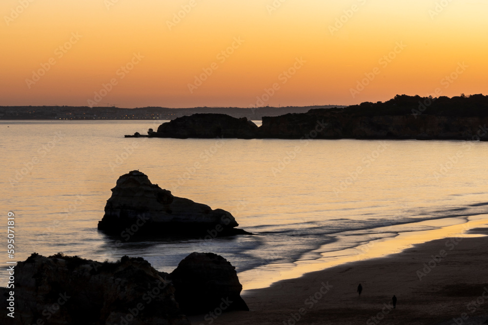 Sunset at Three castle beach in Portimao city