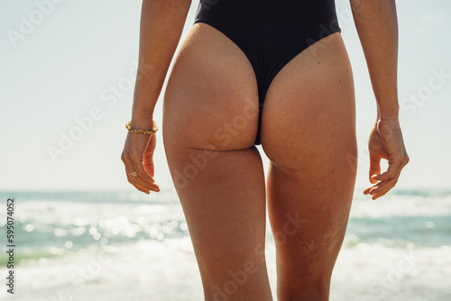 Fotografija beautiful female butt close-up on the background of the sea