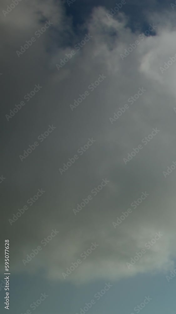 Heavy cumulus rain clouds in the sky, accelerated video, timelapse. The sky is like a background. Vertical video. Heavy cumulus rain clouds in the sky, accelerated video, timelapse. The sky is like a background. Vertical video.