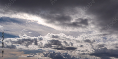 Gray cumulus clouds in the sky. Dramatic skies, landscape. The sky is like a background. White clouds and blue sky