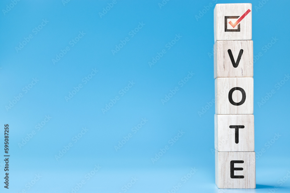 Vote word with checkmark symbol on wooden cube blocks. Political election campaign logo. Applicable as part of badge design. Voting and polling symbols design.Election vote in 2023 concept. Vote word with checkmark symbol on wooden cube blocks. Political election campaign logo. Applicable as part of badge design. Voting and polling symbols design.Election vote in 2023 concept.