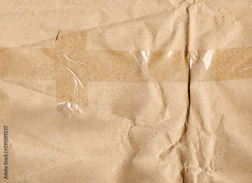 Textured cardboard with a deep wrinkled fold and pasted adhesive tape