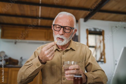 senior man caucasian grandfather take drug tablet drink painkillers