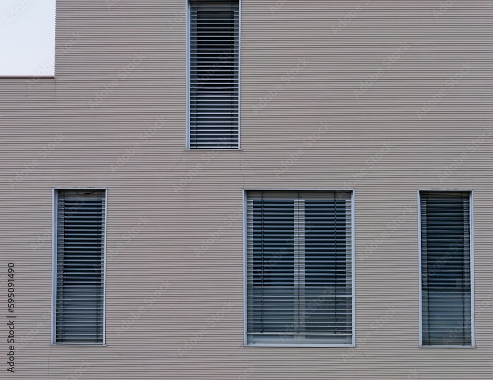 Grayish-brown textured wall with window blinds.