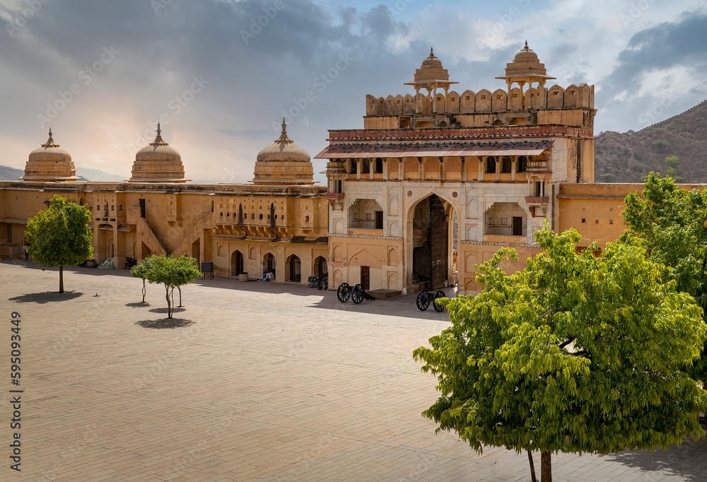 Fototapeta premium Amber Fort illuminated by warm light of the rising sun and reflected in the lake. Famous Rajasthan landmark