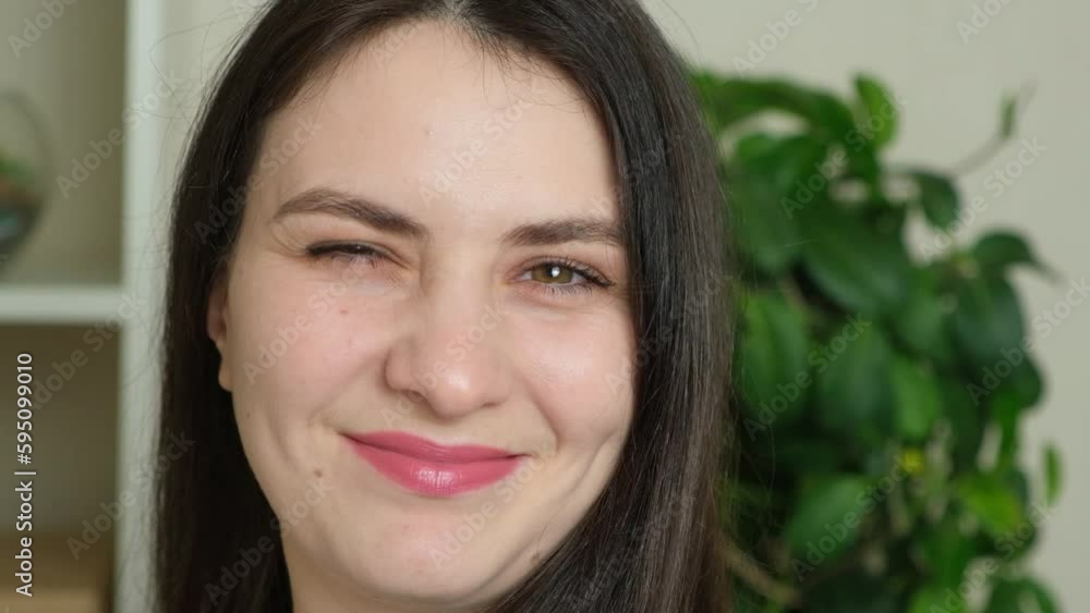 Portrait of a 30-year-old woman turning to the camera and winking Portrait of a 30-year-old woman turning to the camera and winking