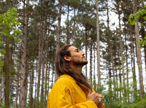 Long hair man in forest photo