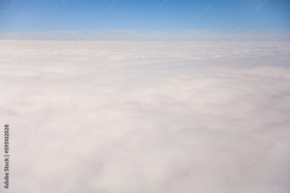 An airplane view of clouds symbolizes freedom, imagination, and perspective. The vast expanse of the sky inspires awe and wonder, offering a sense of detachment from the daily grind 