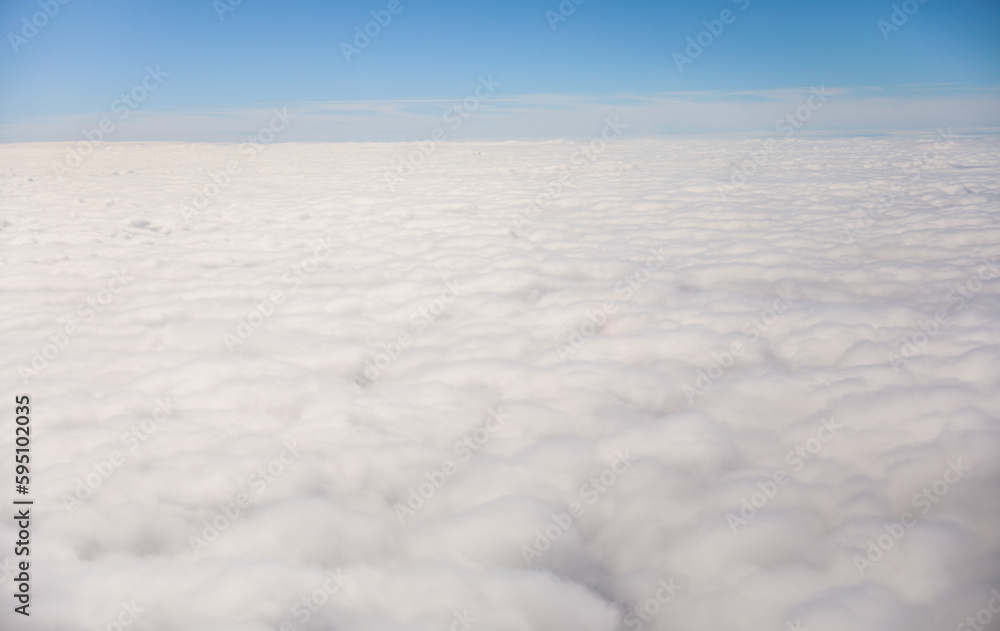 An airplane view of clouds symbolizes freedom, imagination, and perspective. The vast expanse of the sky inspires awe and wonder, offering a sense of detachment from the daily grind 