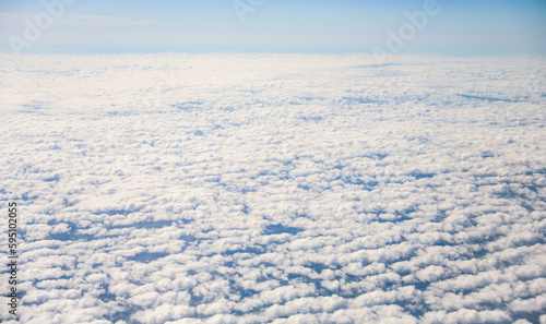 An airplane view of clouds symbolizes freedom  imagination  and perspective. The vast expanse of the sky inspires awe and wonder  offering a sense of detachment from the daily grind 
