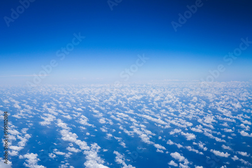 An airplane view of clouds symbolizes freedom, imagination, and perspective. The vast expanse of the sky inspires awe and wonder, offering a sense of detachment from the daily grind  © Your Hand Please